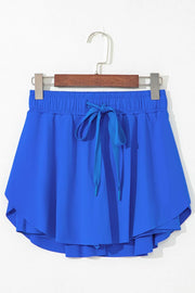 Blue active skort displayed on a hanger, showing the back and layered hem