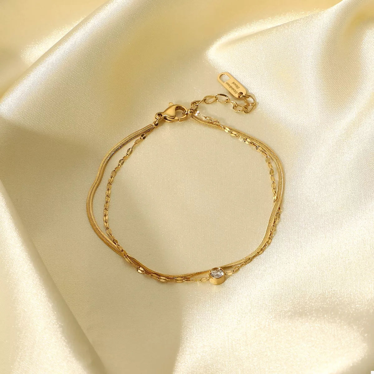 Gold zircon bracelet displayed on a neutral background