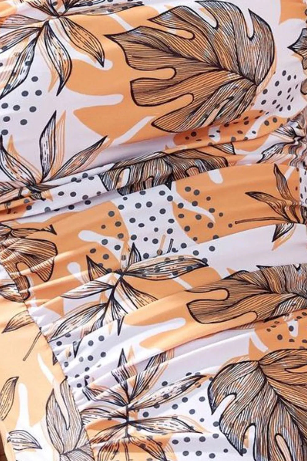 Close-up of the peach, tan and brown leaf pattern on the swimsuit fabric