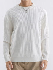 Front view of ivory ribbed crew-neck sweater showing long sleeves and ribbed hem