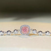 Front view of a pink square center stone framed by clear stones and round side accents