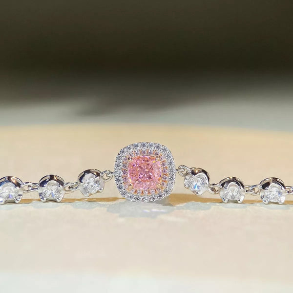 Front view of a pink square center stone framed by clear stones and round side accents