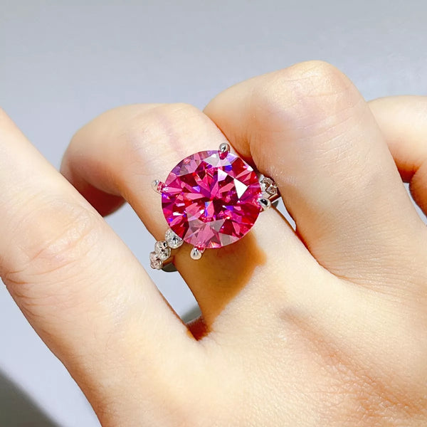 Hot pink round-stone ring worn on hand