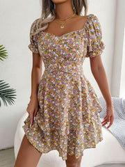 Three-quarter view of yellow floral dress with layered flared skirt