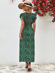Front view of green printed flutter-sleeve dress with a V-neck and straight ankle-length skirt.