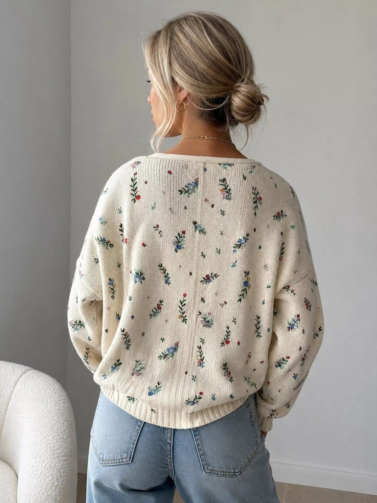 Back of cream floral cardigan showing scattered flower pattern