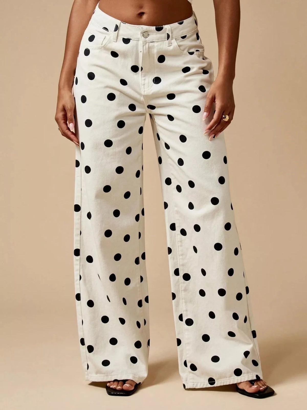 Cream wide-leg jeans with large black polka dots, front view