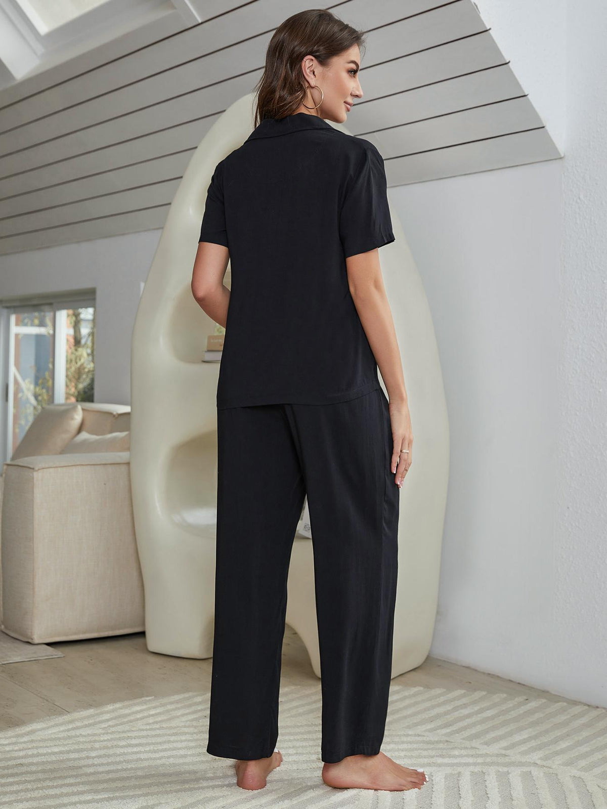Black lounge set with short-sleeve shirt and straight-leg pants, side view