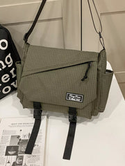 Olive green fine-check messenger bag with front zip pocket, side pockets and two buckle straps