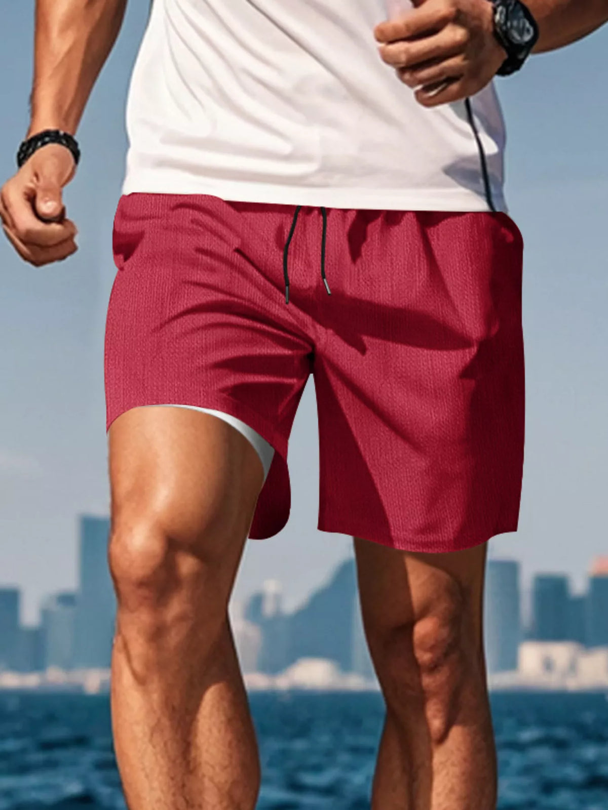 Side view of red drawstring shorts on a model