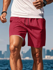 Side view of red drawstring shorts on a model