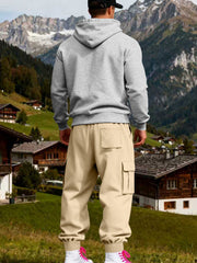 Back view of light grey hoodie and beige sweatpants showing the hood and rear pocket