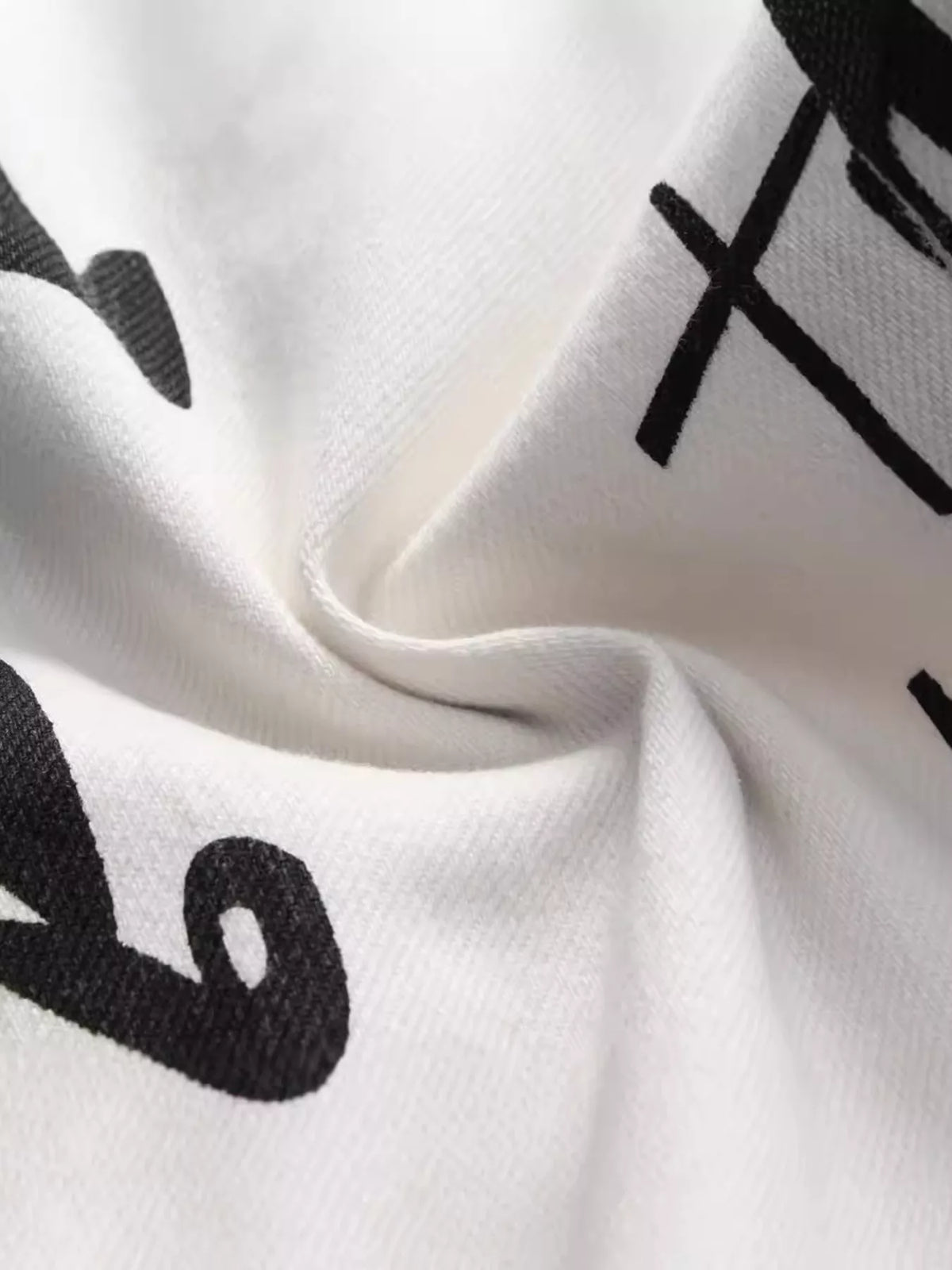 Close-up of black graphic print on white denim