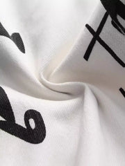 Close-up of black graphic print on white denim