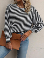 Black-and-white striped top with lantern sleeves and round neckline