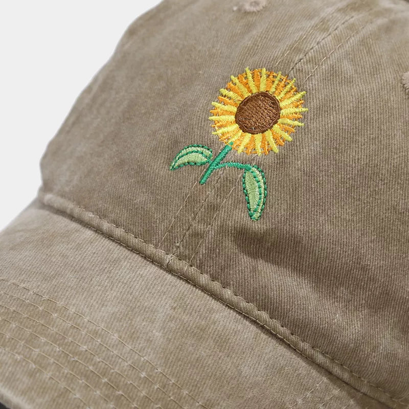 Close-up of sunflower embroidery on the khaki baseball cap