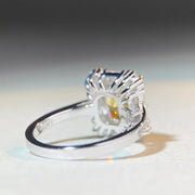 Side profile of a rectangular yellow gemstone ring showing its elevated setting