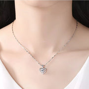 Model wearing a small heart pendant necklace