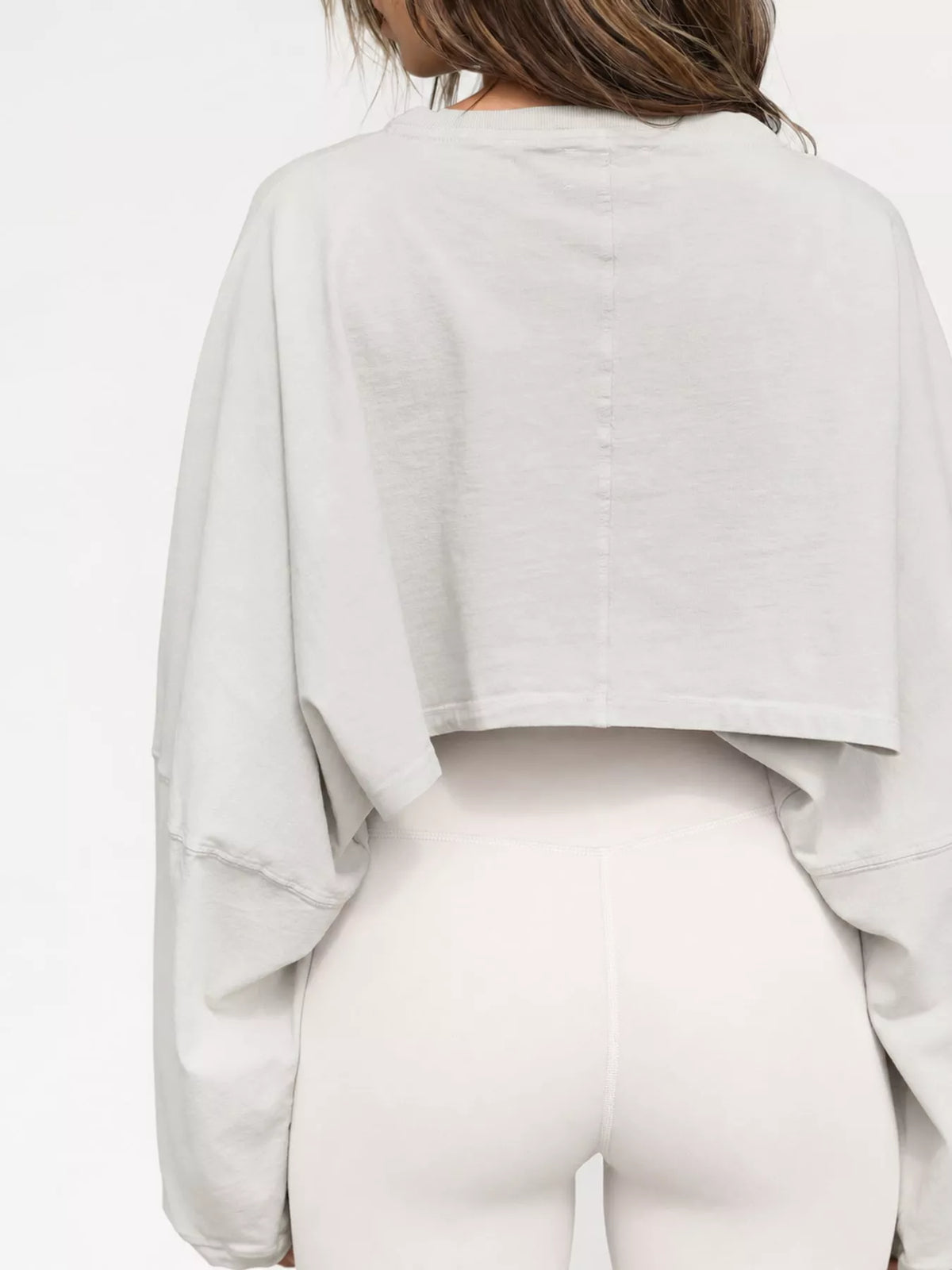 Back view of the light gray cropped sweatshirt with long sleeves