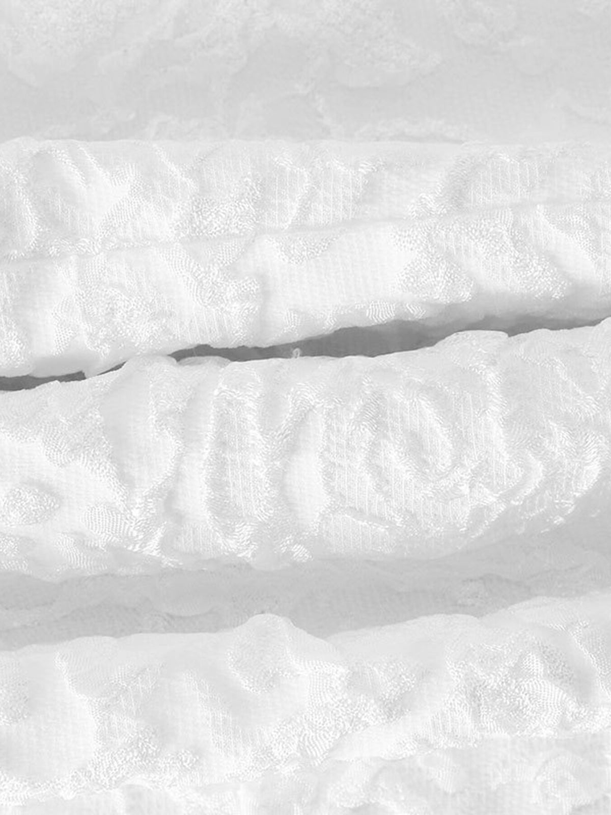 Close-up showing layered surface texture across dress fabric