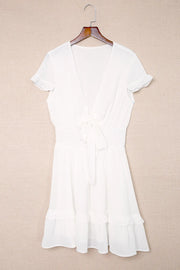 White dress displayed on hanger, front