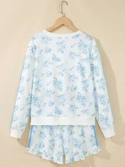 Back of white floral sweatshirt and matching shorts on a hanger
