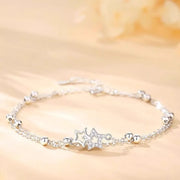 Silver star bracelet with rhinestone star charms laid flat