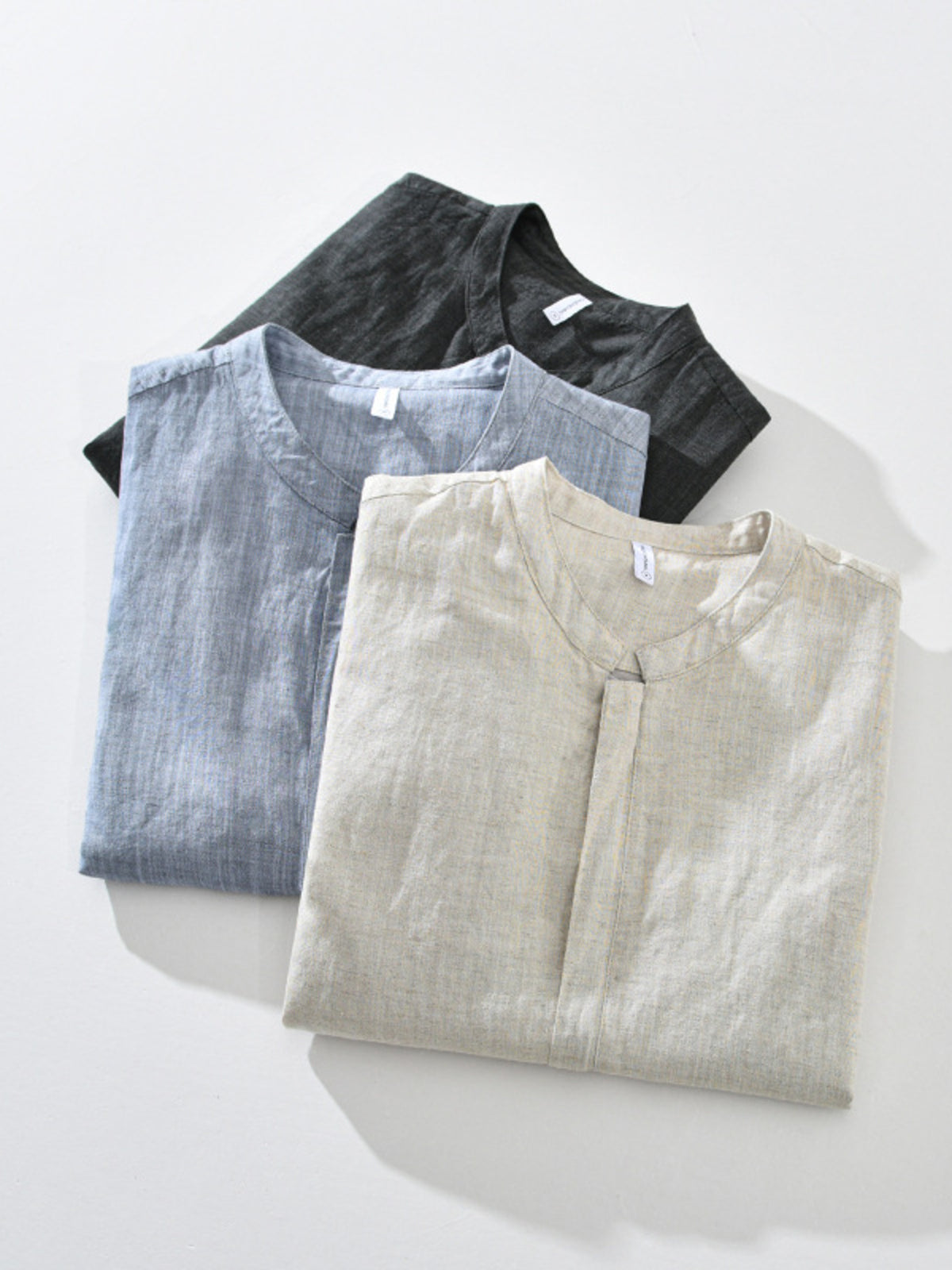 Blue and cream zip-up jackets shown together on hangers