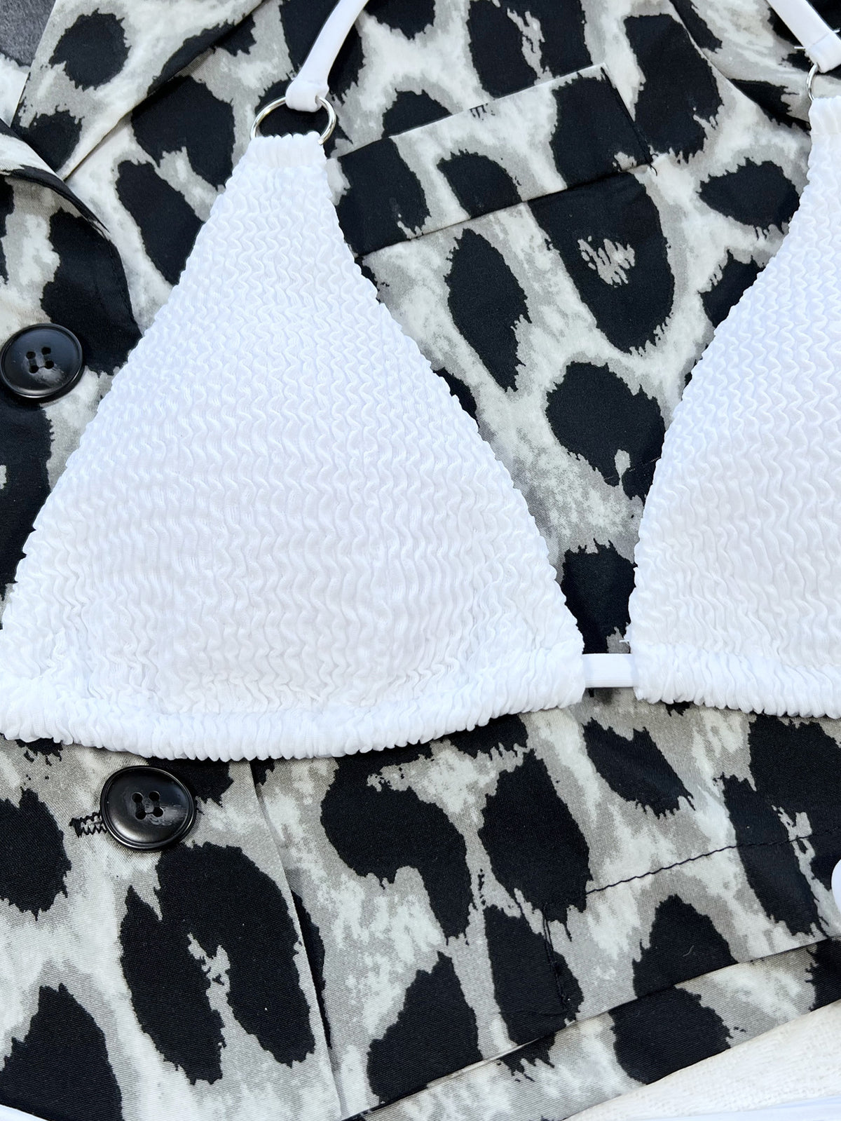 White bikini bottoms and halter top laid flat