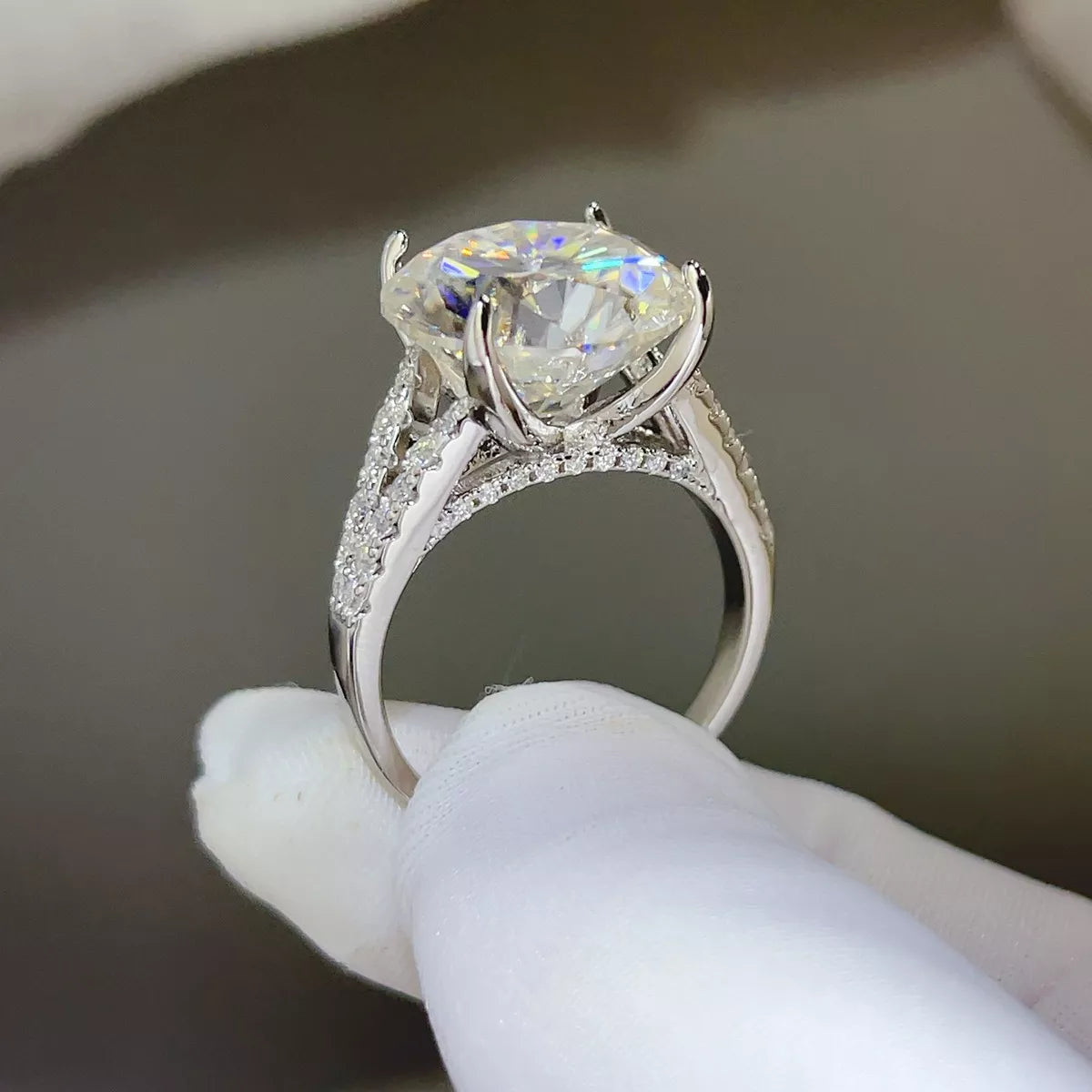 Side profile of the elevated center stone and pavé-style shoulders on the ring