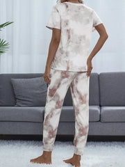 Back view of a model wearing a pale tie-dye top and matching lounge pants