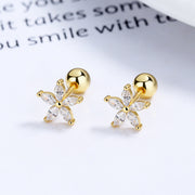 Pair of gold-tone flower studs with clear stones, angled view