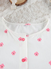 Close-up of pink flower print and buttons on ribbed lounge top