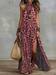 Pink leopard-print halter maxi dress with a high side slit, full-length front view.