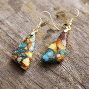 Close view of gold-tone hooks and multicolour geometric drops