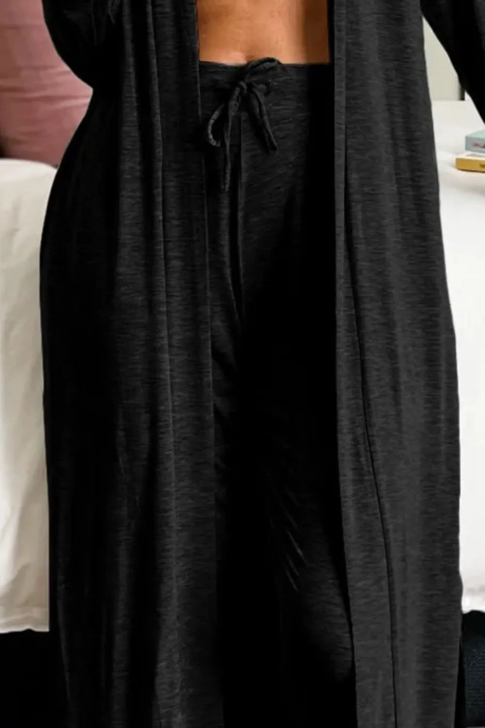 Black lounge pants and long cardigan shown from the waist down
