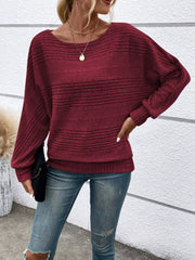 Women’s ribbed round-neck long-sleeve top in burgundy front view with hand at hip
