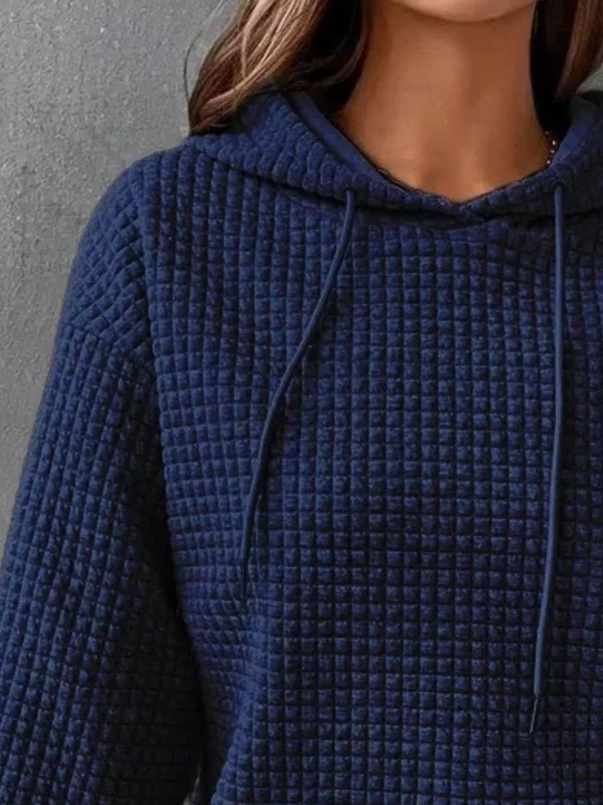 Close view of navy hoodie texture and hood