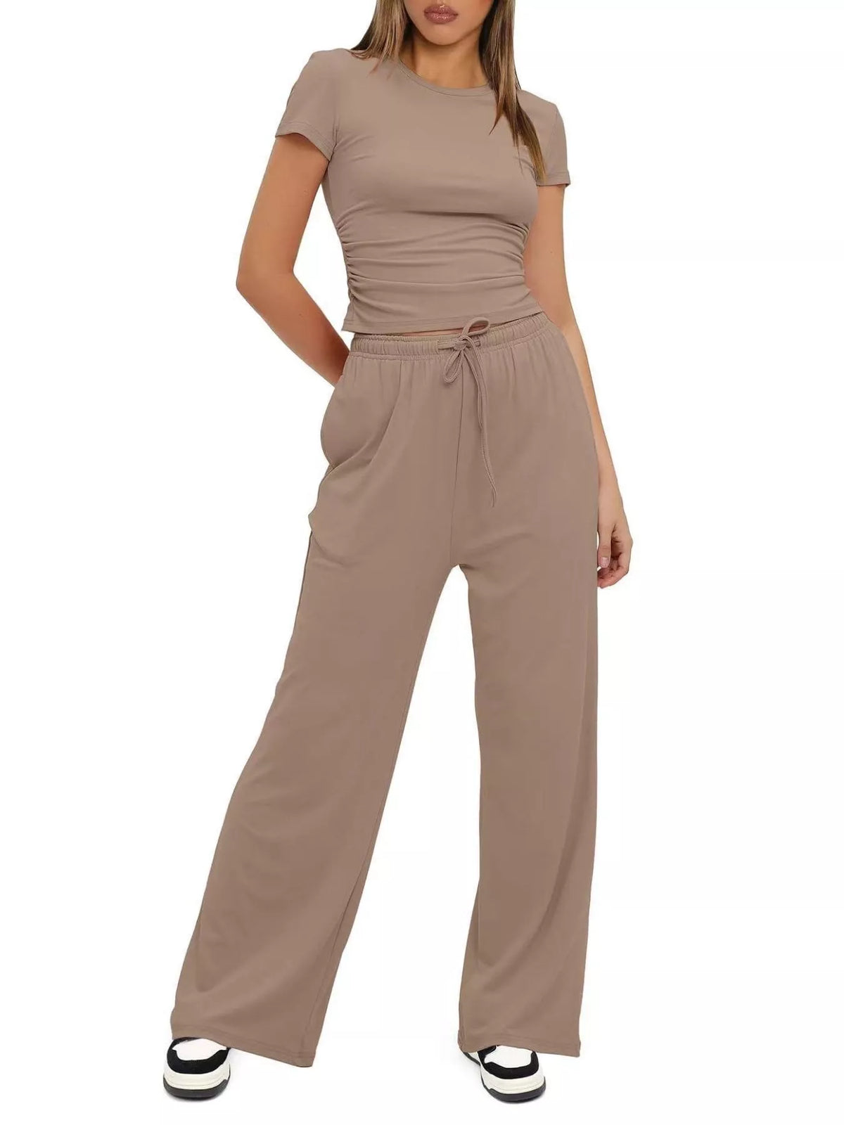 Three-quarter view of the taupe set showing the fitted sleeveless top and loose pants.
