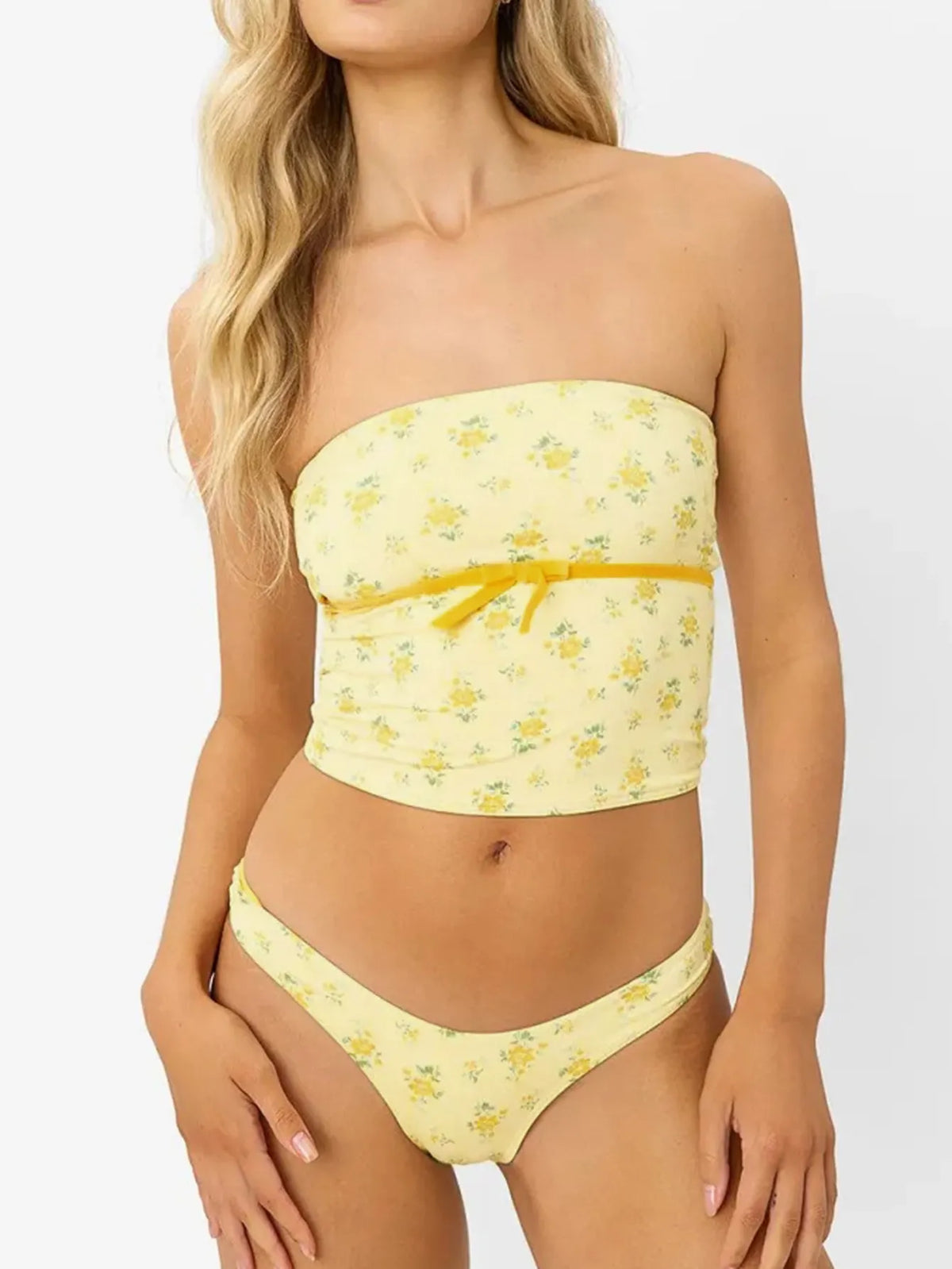 Front view of pale yellow floral bandeau top with matching bottoms on a model.