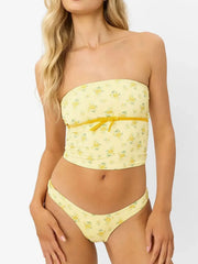 Front view of pale yellow floral bandeau top with matching bottoms on a model.