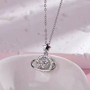 Moissanite planet pendant necklace displayed on a pale surface