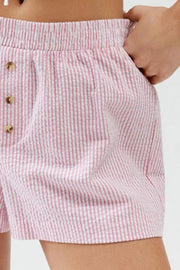 Close-up of pale pink stripe fabric and shorts hem