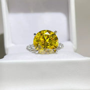 Yellow round-stone ring displayed in a white jewellery box