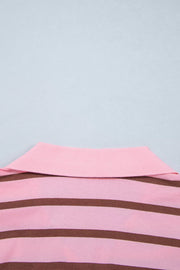 Close-up of the shirt hem and horizontal pink-brown stripes.