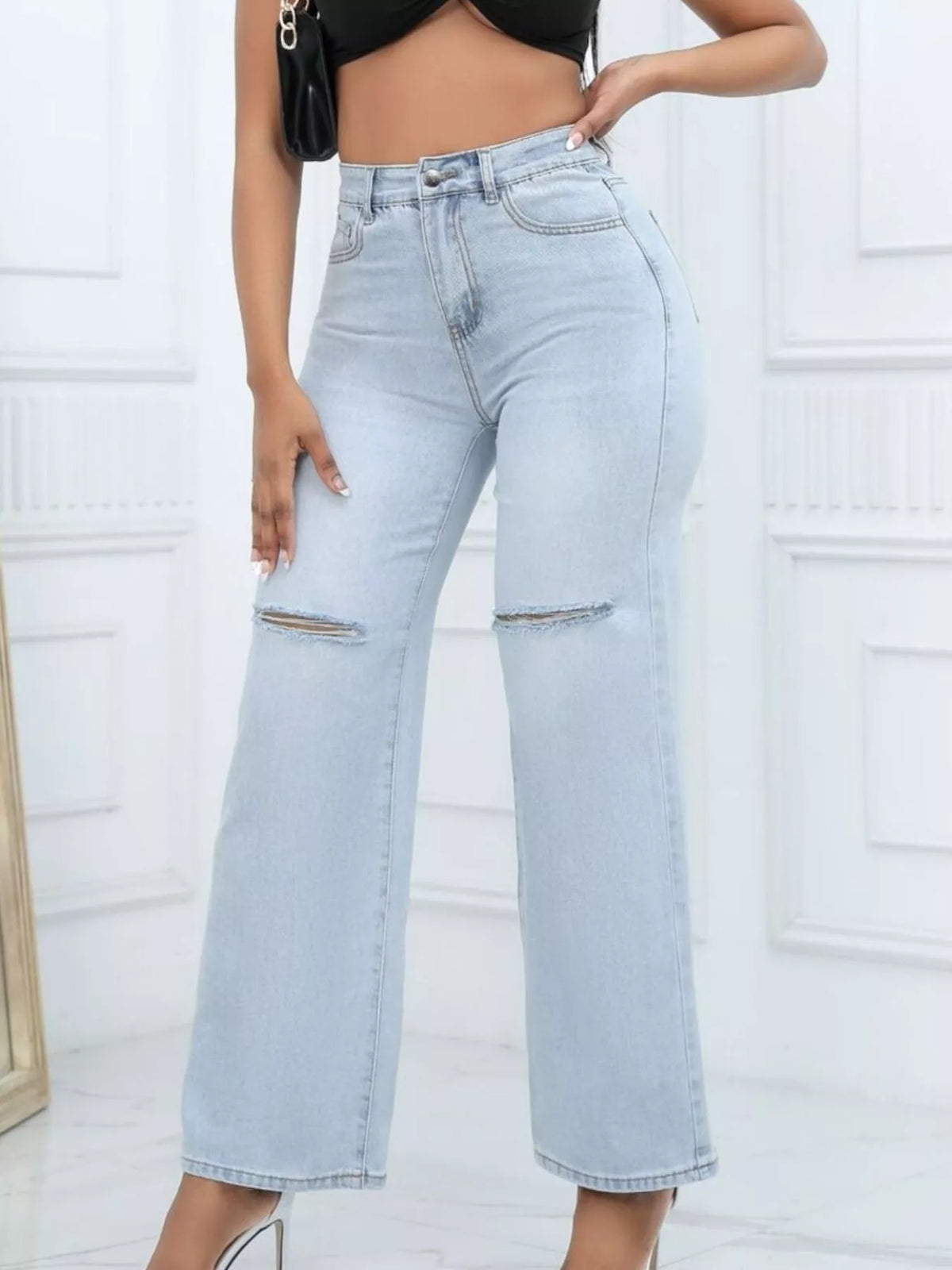 Light-wash wide-leg jeans with horizontal knee rips, front view