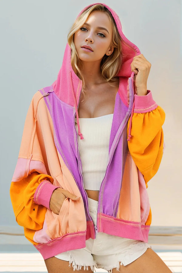 Back view of pink, peach, and orange color-block hoodie with hood and zip closure.