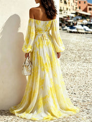 Rear view of the yellow-and-white maxi dress with a bow at the waist