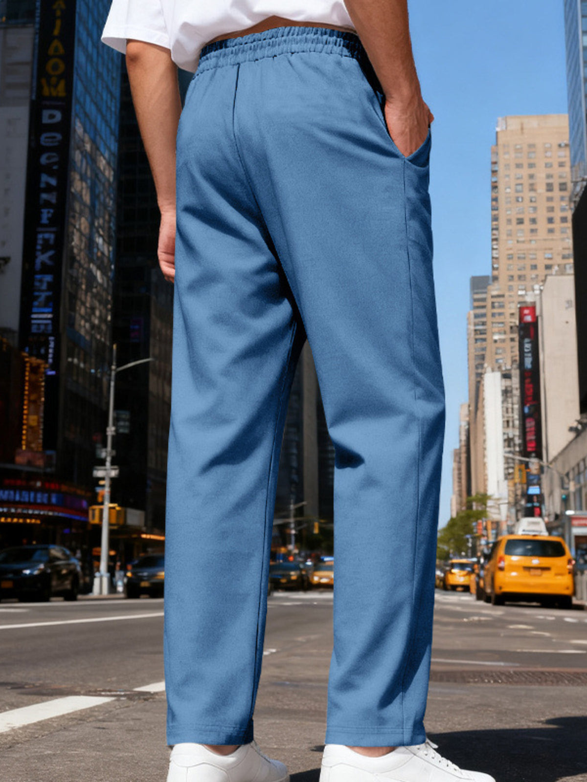 Front view of gray straight-leg pants with drawstring waist near the Statue of Liberty.
