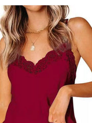Close-up of burgundy camisole with dark scalloped floral lace at the neckline